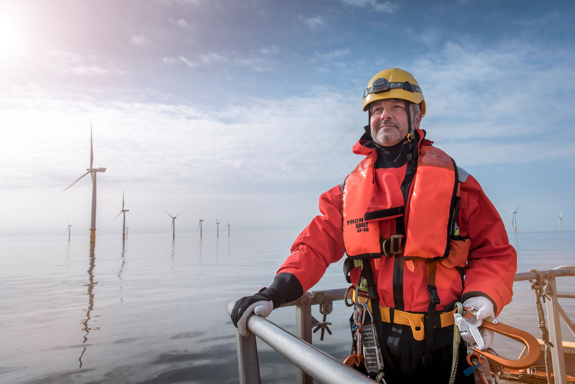 Offshore worker on a platform near wind turbines